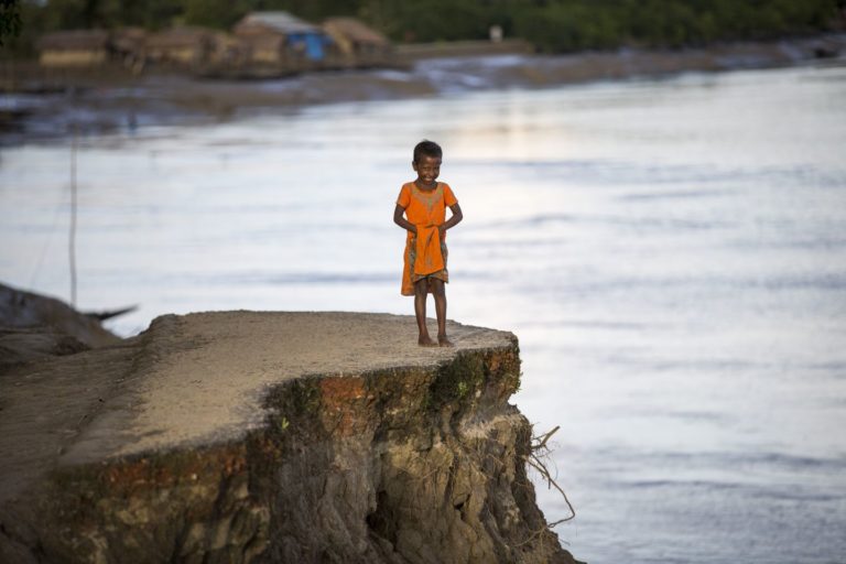 A child on an eroded shore