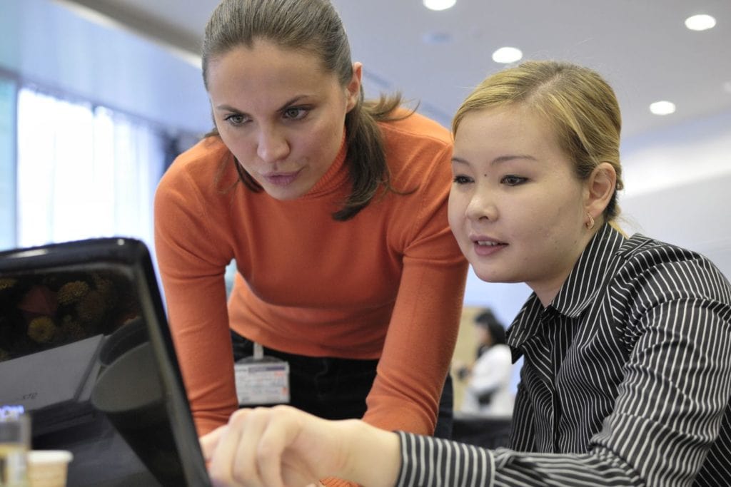 Two women looking at a laptop