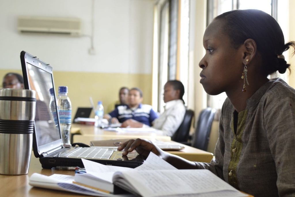 A woman working at a laptop