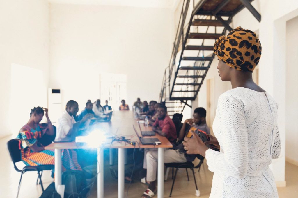 A woman gives a lecture to a group of people