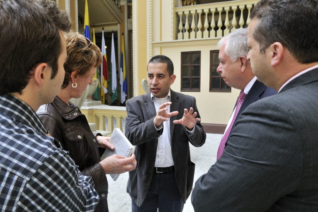 A man explains something to four people