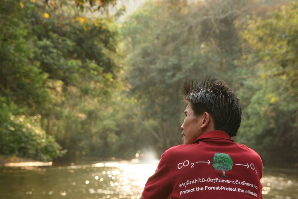 A man on a boat in the forest