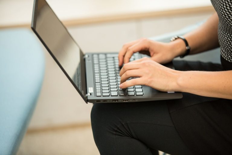 Hands writing on a keyboard