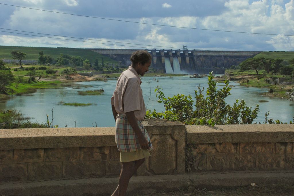 A man in front of a dam