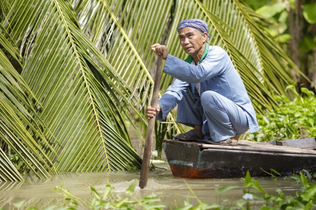 A man on a boat in the forest